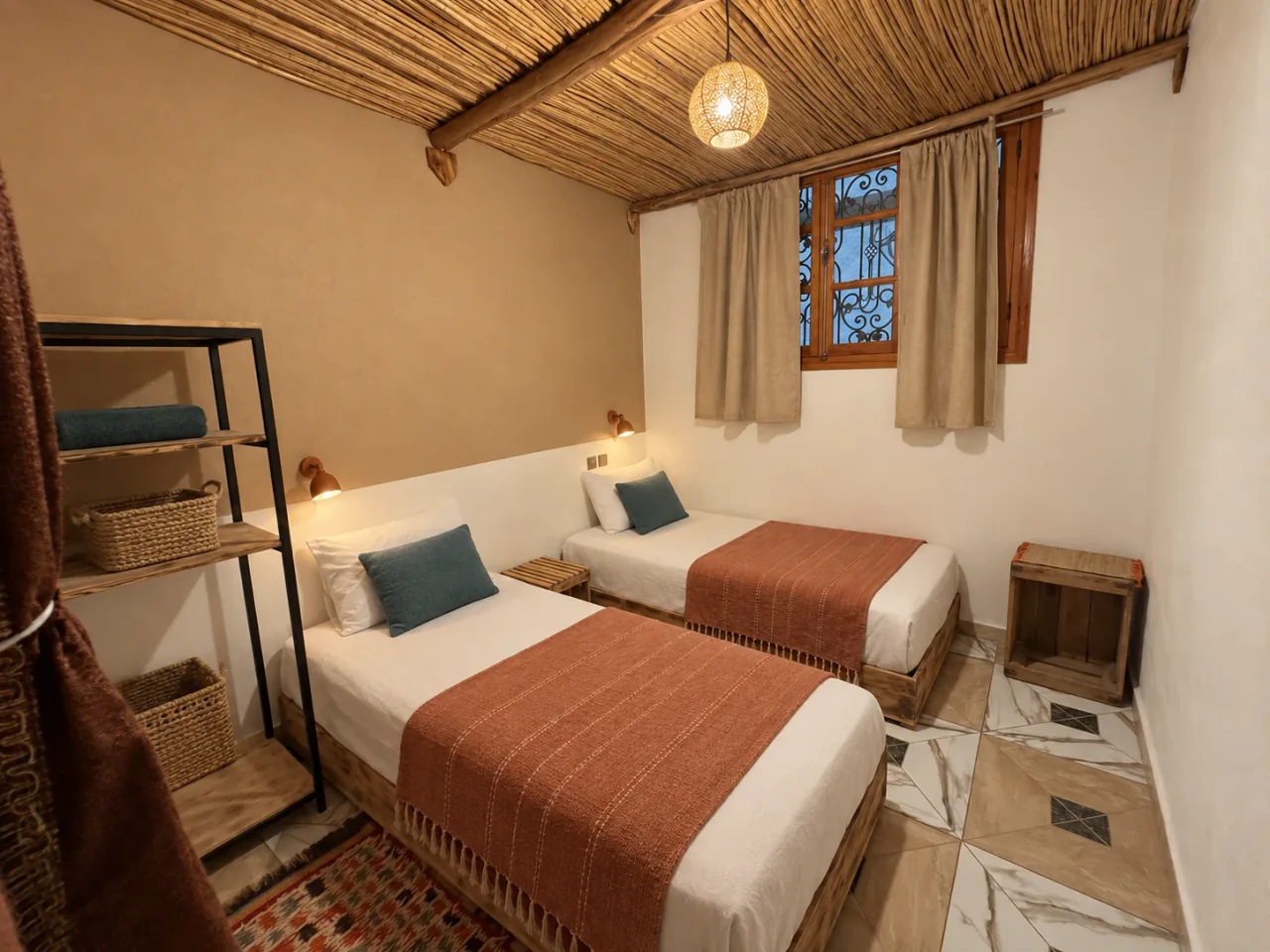 Twin beds with woven reed ceilings, clay throws and blue cushions