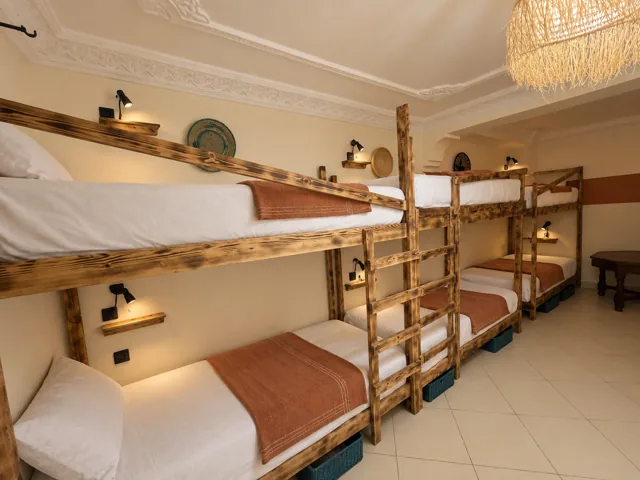 Timber bunk beds with ocean blue bedding in a shared room